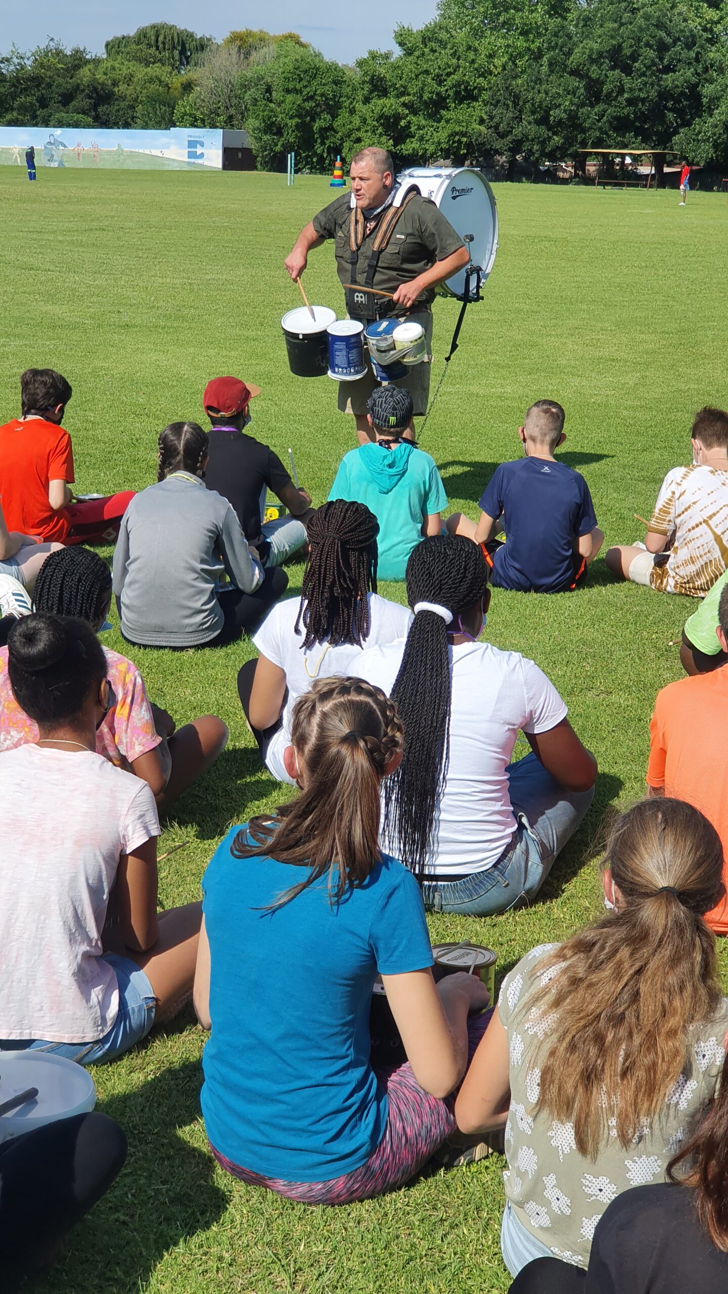 Participants taking part in the Ayoba Jam on Junk team building activity, creating music together to develop teamwork, communication and creativity.