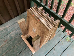 Stepping Words team building letter tiles neatly packed in an organized storage holder.